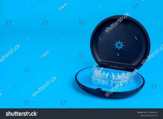 stock-photo-black-plastic-case-with-transparent-braces-on-blue-background-insivible-removable-retainers-for-2121606305